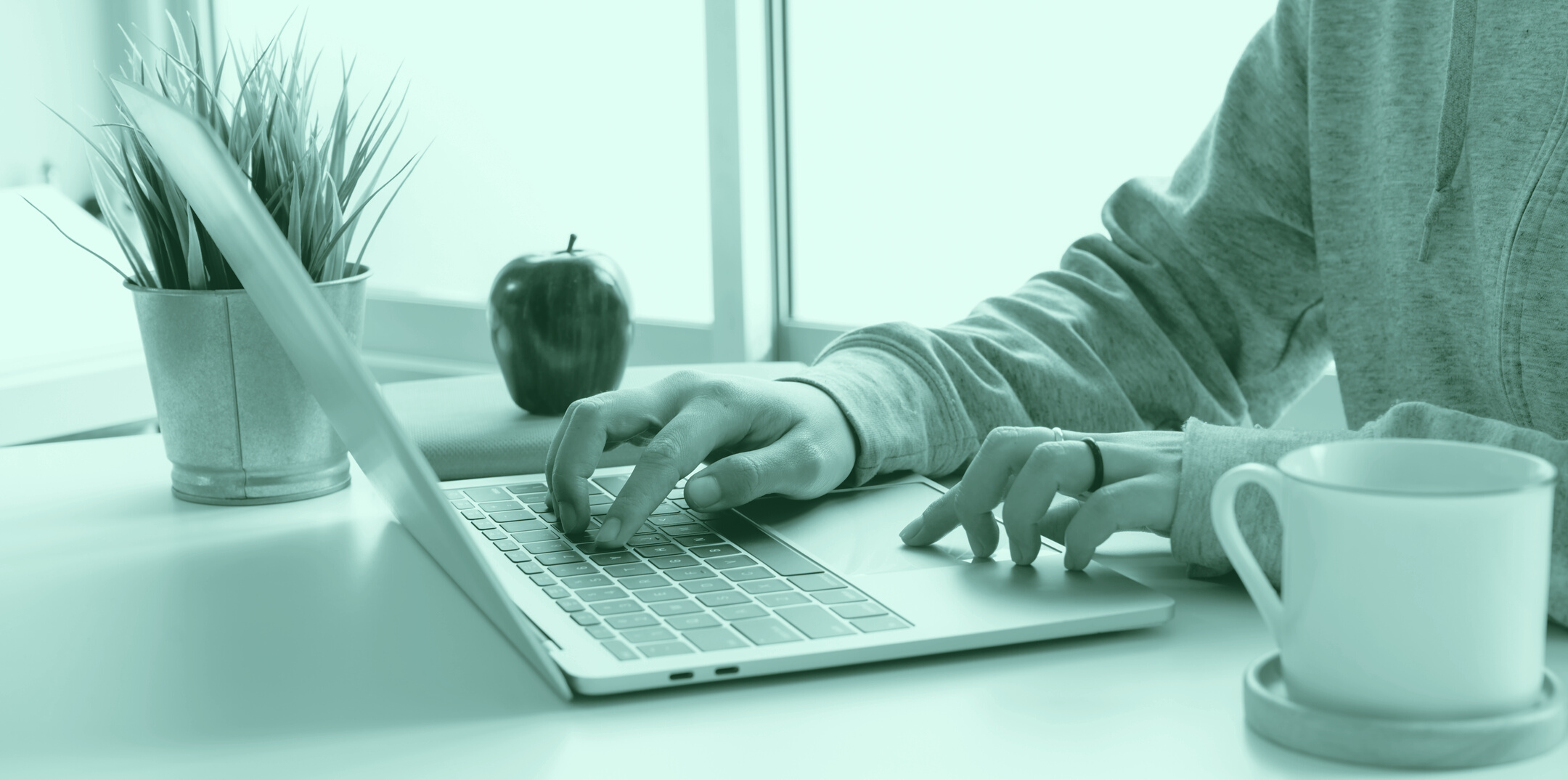 Person in Gray Long Sleeve Top Using Mac-book Pro