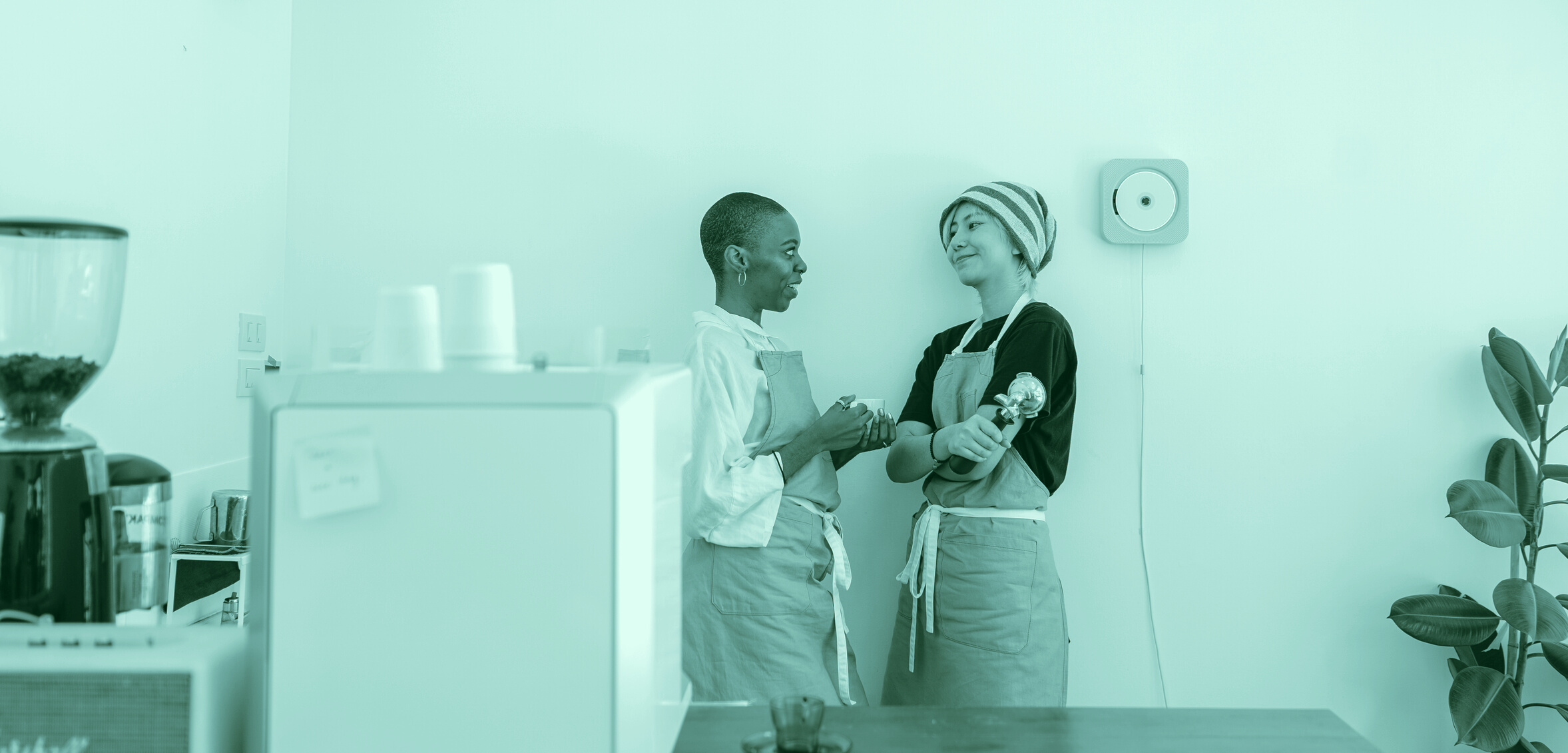 Friendly diverse couple of women communicating in coffee house