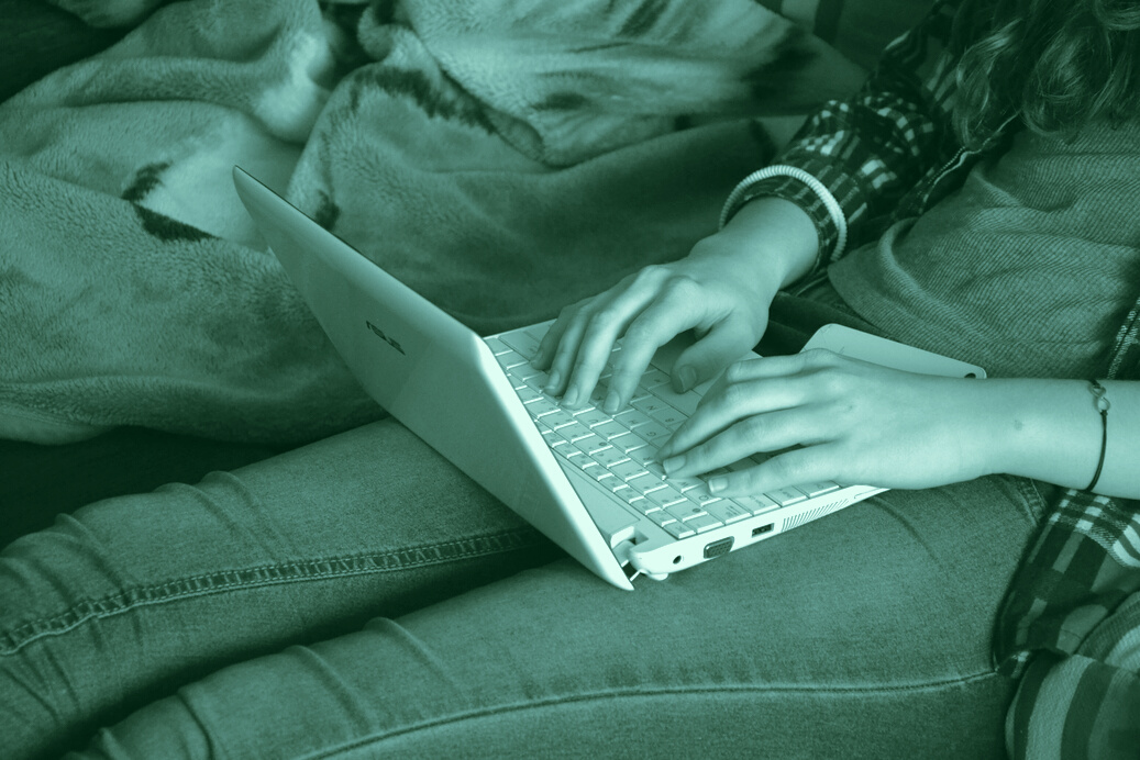 Student Typing at the Laptop
